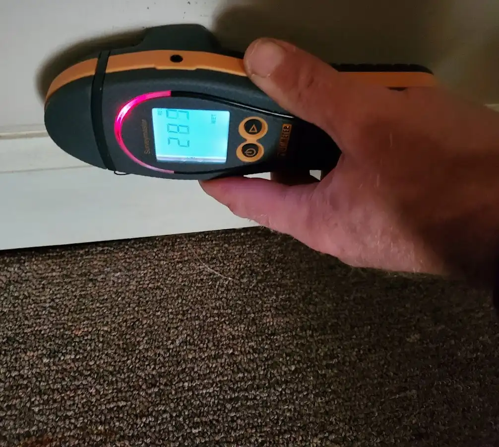 Moisture detection at baseboard during Storm Damage Restoration in Barling